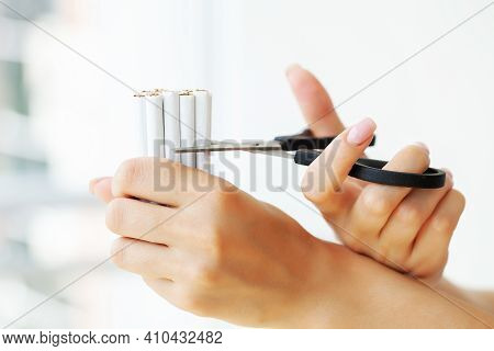 Stop Smoking, Woman Cuts A Cigarette With Scissors