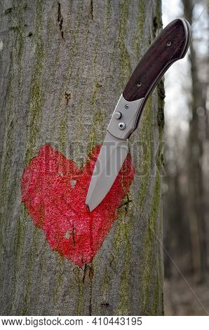 A Sharp Knife Pierced A Red Heart Painted On A Tree