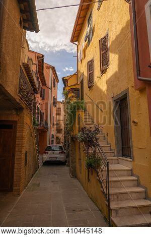 Modern Cars On Street Of  Medieval Town Of Orte In Italy.