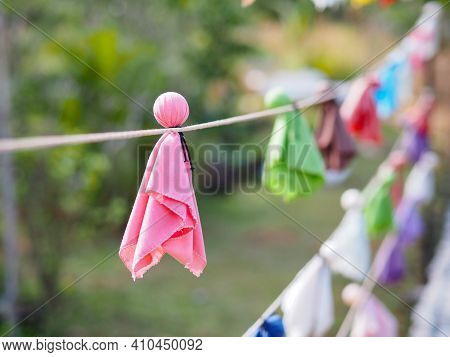 Close Up Japanese Fabric Rain Doll Or Teru Teru Bouzu Hanging In Row At Japan Garden.