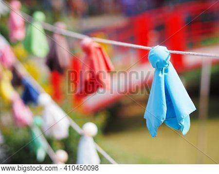 Close Up Japanese Fabric Rain Doll Or Teru Teru Bouzu Hanging In Row At Japan Garden.
