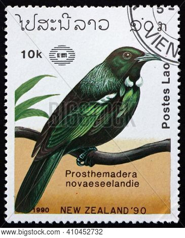 Laos - Circa 1990: A Stamp Printed In Laos Shows Tui, Prosthemadera Novaeseelandie, Is An Endemic Pa