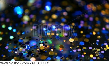 Defocused Shimmering Multicolored Glitter Confetti, Black Background. Holiday Abstract Festive Bokeh