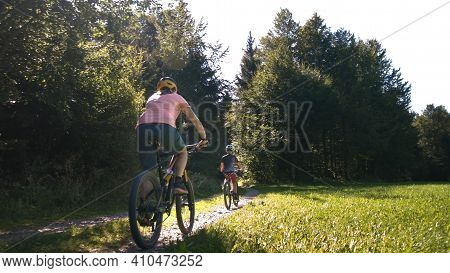 Two Girls On Mtb Bikes. Mother And Daughter Riding On A Forest Trail.