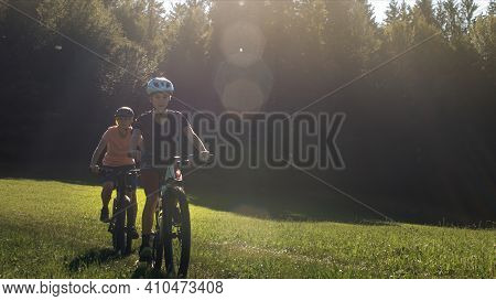 Two Girls On Mtb Bikes. Mother And Daughter Riding On A Forest Trail.
