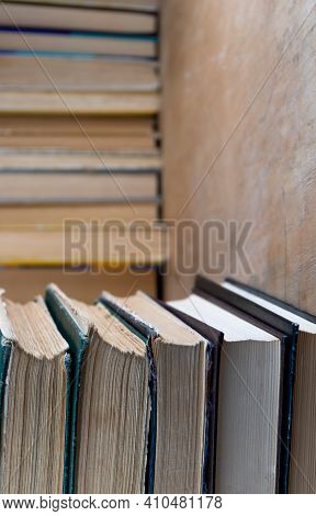 Collection Of Old Books On Wooden Background. Book In The Library. Bookshelf Shop. Knowledge Publica