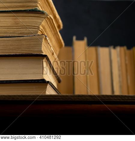 Collection Of Old Books On Wooden Background. Book In The Library. Bookshelf Shop. Knowledge Publica