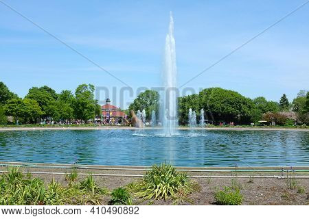 BROOKFIELD, ILLINOIS - MAY 27, 2017: Roosevelt Fountain at the Brookfield Zoo. In the background is the popular Carousel Ride.