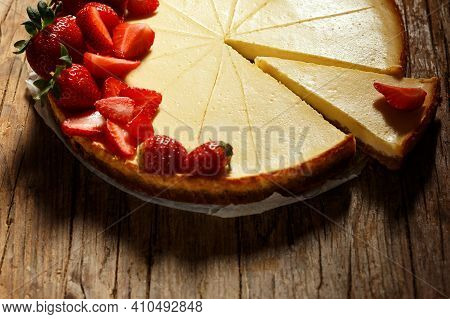 Top Viev. Delicious Homemade Creamy Mascarpone New York Cheesecake With Berries On Dark Wooden Table