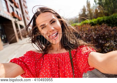 Photo Of Funky Happy Funny Young Woman Blink Take Face Selfie Windy Weather Outside In City Center O