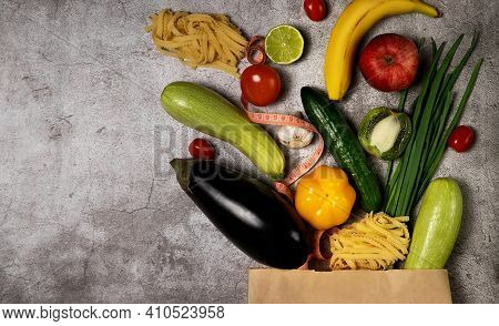 Healthy Lifestyle And Food Concept. Vegetables And Fruits Falling Out From Paper Pocket, Cucumber, T