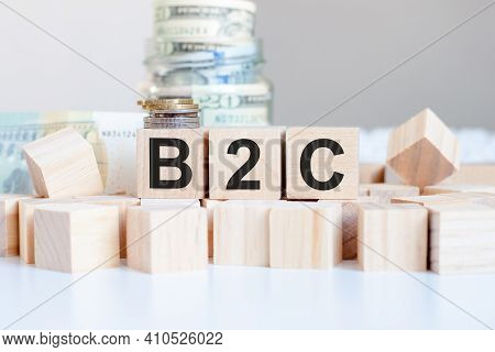 The Word B2c On The Wooden Blocks And A Bank With Money In The Background, Business Concept, B2c Sho