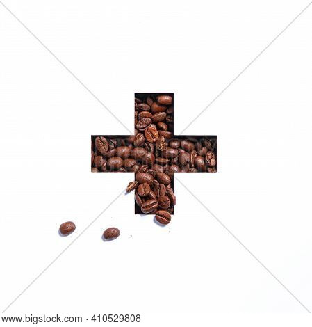 Plus Summation Sign Or Cross Of Coffee Beans And Cut Paper Isolated On White