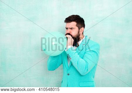 Man Inflating A Blue Balloon. Bearded Man With Balloon. Happy Birthday. Preparation To Party, Celebr