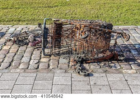 Rusty And Damaged Shopping Cart Found In The Port Of Kiel In Germany