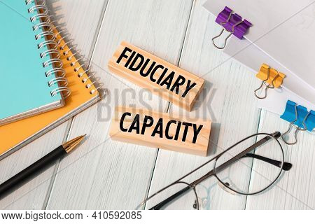 Fiduciary Capacity - Words Written On Wooden Blocks Near Office Supplies