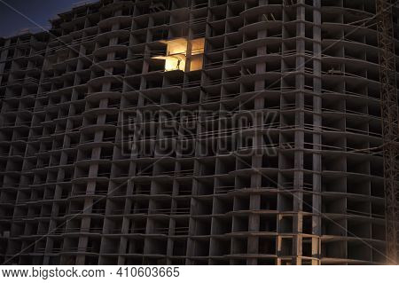 House Under Construction In The Evening With A Luminous Opening