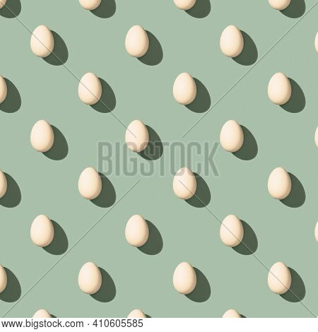 Pattern Made Of White Eggs On Pastel Green Background. Minimal Food Concept. Flat Lay