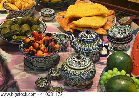 The Traditional Food In Central Asia With Treats, Food And Old National Musical Instruments. Inside 