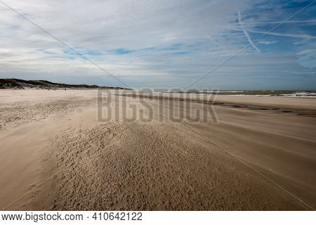 The North Sea Beach On A Sunny Stormy Winter Day With Drifting Beach Sand Near The Slufter Valley On