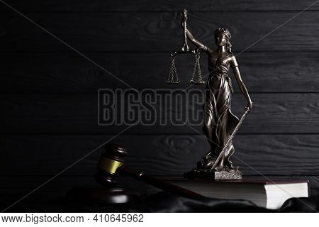 The Statue Of Justice - Lady Justice Or Justitia The Roman Goddess Of Justice. Statue On Brown Book 