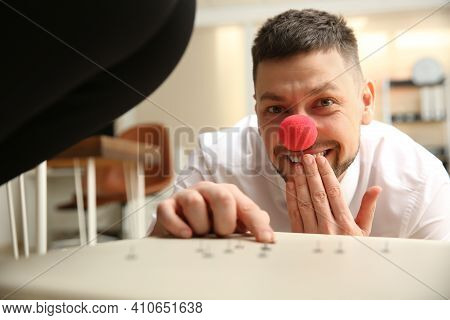 Man Putting Pins On Chair While His Colleague Sitting Down In Office, Closeup. Funny Joke