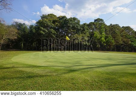 Background Of Evening Golf Course Has Sunlight Shining Down At Golf Course. Nice Scenery On A Golf C