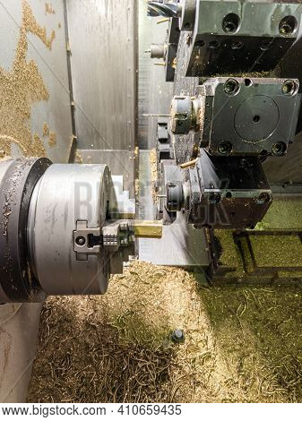 Cnc Lathe With Lot Of Brass Swarf Inside While Turning Hexagonal Yellow Metal Rod Workpiece