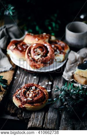 Brunost Caramel Cinnamon Buns A Wooden Table . Dark Rustic Photo.selective Focus