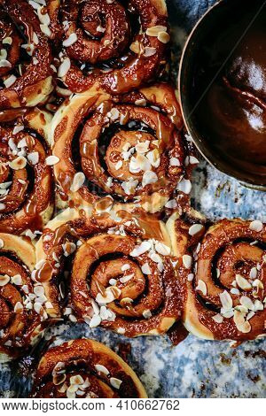 Brunost Caramel Cinnamon Buns A Wooden Table . Dark Rustic Photo.selective Focus