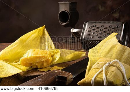 Pamonha, Brazilian Corn Food, Called Pamonha. On A Rustic Table With Knife And Old Corn Grater, Low
