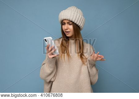 Side-profile Photo Of Beautiful Young Blonde Woman Wearing Stylish Beige Warm Sweater And Knitted Wi