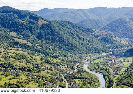 Ukraine Carpathians, A Settlement In A Valley Of Mountains, Beautiful Landscape Aerial View.