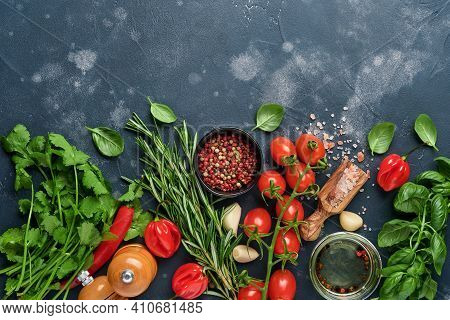 Food Cooking Background. Fresh Rosemary, Cilantro, Basil, Cherry Tomatoes, Peppers And Olive Oil, Sp