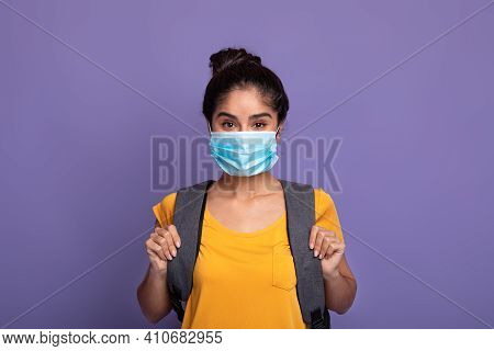 Return Back To School And Lockdown. Portrait Of Smilling Indian Female Student Wearing Surgical Medi