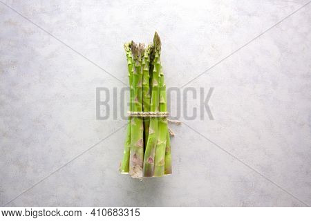 Bunch Of Asparagus Tied With Jute Rope On Whtie Background.