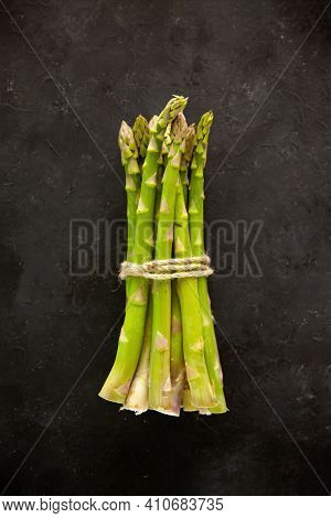 Bunch Of Asparagus Tied With Jute Rope On Black Or Dark Grey Background.