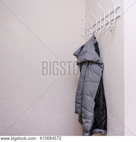 Wintercoat Hanging On A Hook In A Corridor, Hallway At The Entrance