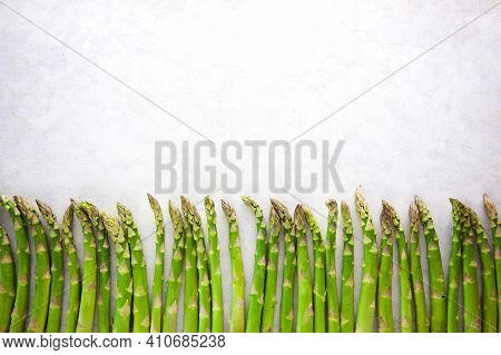 Bunch Of Asparagus Arranged In A Row On Dark Grey And White Background With Copy Space. Green Aspara