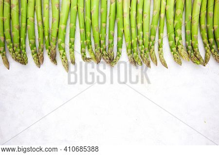 Bunch Of Asparagus Arranged In A Row On Dark Grey And White Background With Copy Space. Green Aspara
