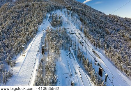 Aerial View Of Ski Jump In Planica, Slovenia At Ratece Near Kranjska Gora In Winter With Snow.