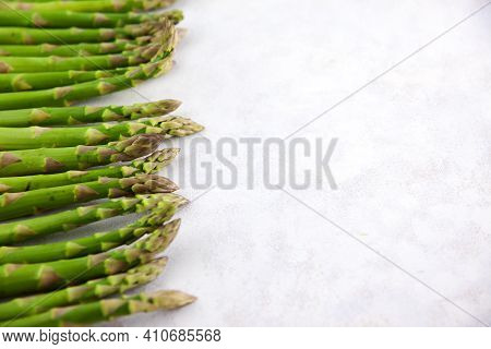 Bunch Of Asparagus Arranged In A Row On Dark Grey And White Background With Copy Space. Green Aspara