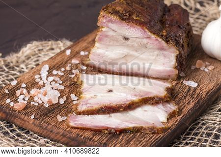 A Piece Of Baked Meat With Layers Of Bacon, Cut From The Bottom Of A Pork Carcass, Along With The Sk