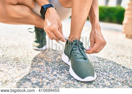 Close up of woman feet wearing training sneakers doing lace ready for running