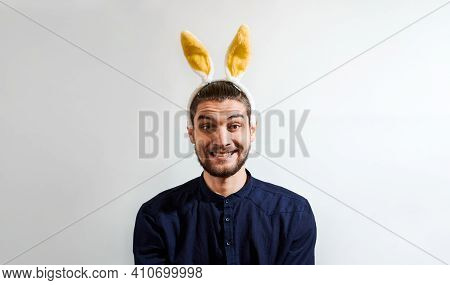 Charming Young Man With Beard In Shirt Wearing Easter Bunny Costume. Man With Rabbit Ears. Persom Wi