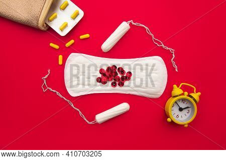 Pink Beautician With Daily Cotton Sanitary Pads, Cotton Tampons And Hormonal Contraceptive On Red Ba
