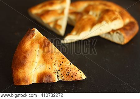 Slices Of Ramadan Pita (ramazan Pidesi) Traditional Turkish Bread For Holy Month Ramadan On Black Ba