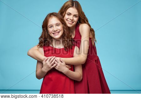 Mom And Daughter In Red Dresses Entertainment Lifestyle Fun Studio Blue Background