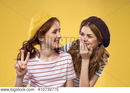 Cheerful Sisters In Hats Striped T-shirts Joy Lifestyle Yellow Background Family