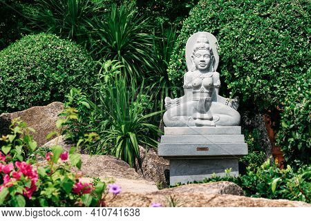 A Statue Of A Flower In The Garden